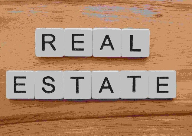 Real Estate  Title on wood background