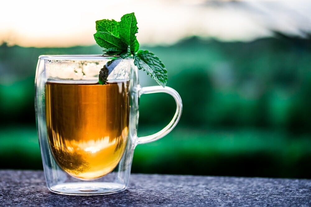 a cup of tea with mint leaves