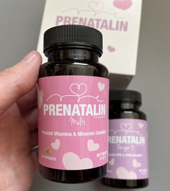 a woman holding prenatalin bottles