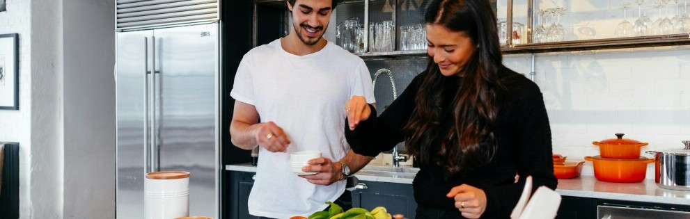 Couple preparing healthy food in their kitchen in support of brain health.