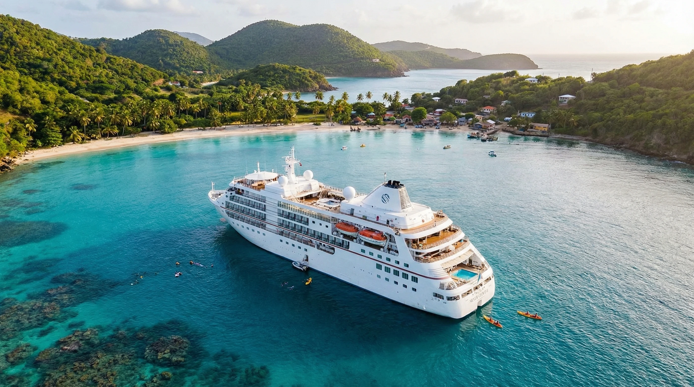 A small luxury cruise ship anchored near a secluded turquoise bay with white sand beaches and lush green hills in the Caribbean