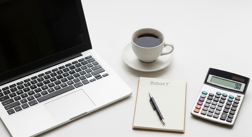 Parent blogger managing blogging expenses while planning new posts.