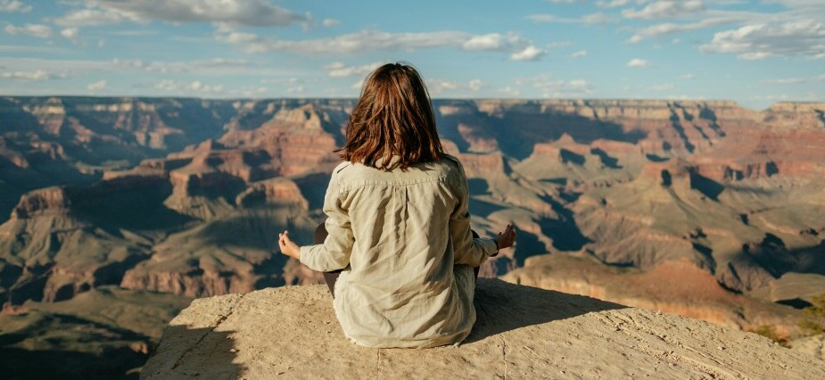 Woman meditating on the hills