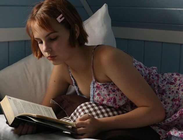 Girl Reading in Bed