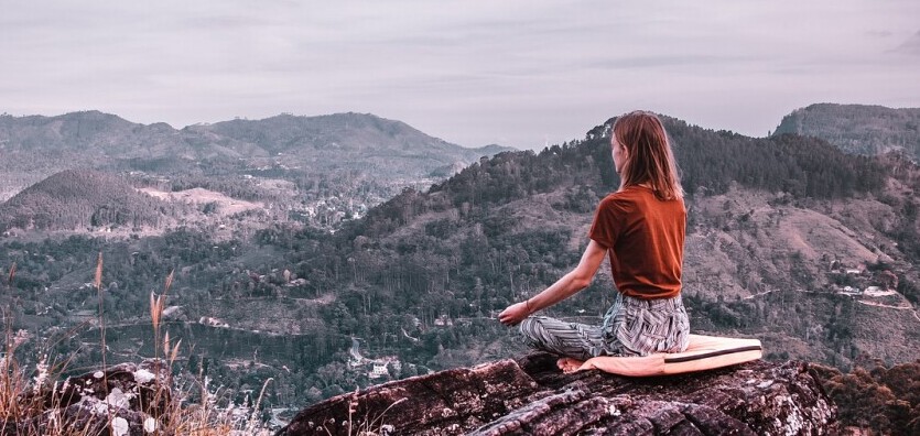 Woman Meditating in the Hills