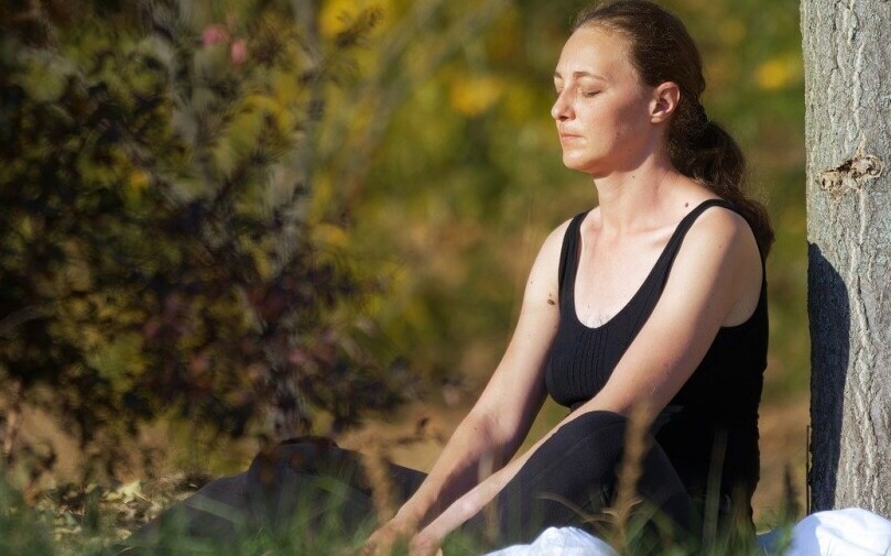 Woman Meditating in the Park